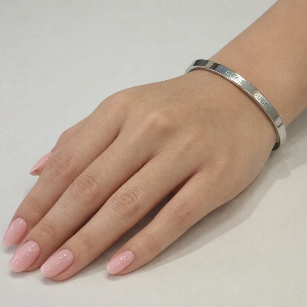 Silver colored monogramed bracelet that opens with pull. New without tags. #154